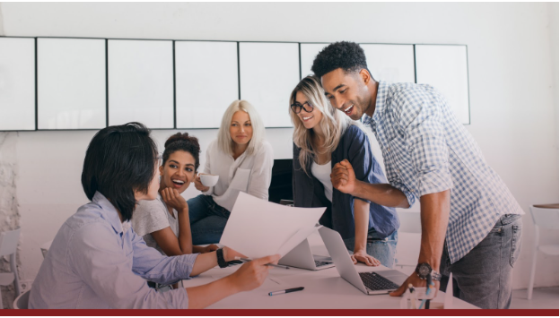 group of colleagues engaged in team work over a table
