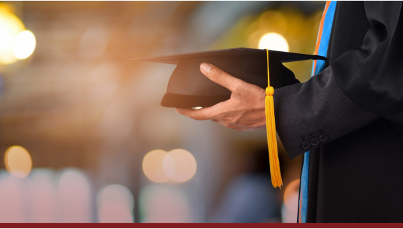 man holding mortarboard